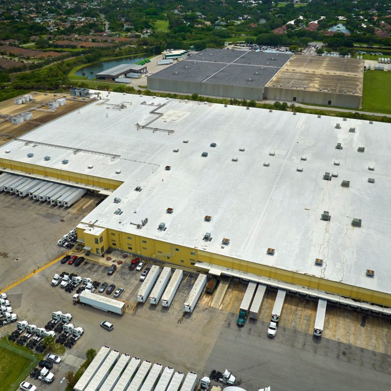 Big corporate shipment center with many cargo semi trucks